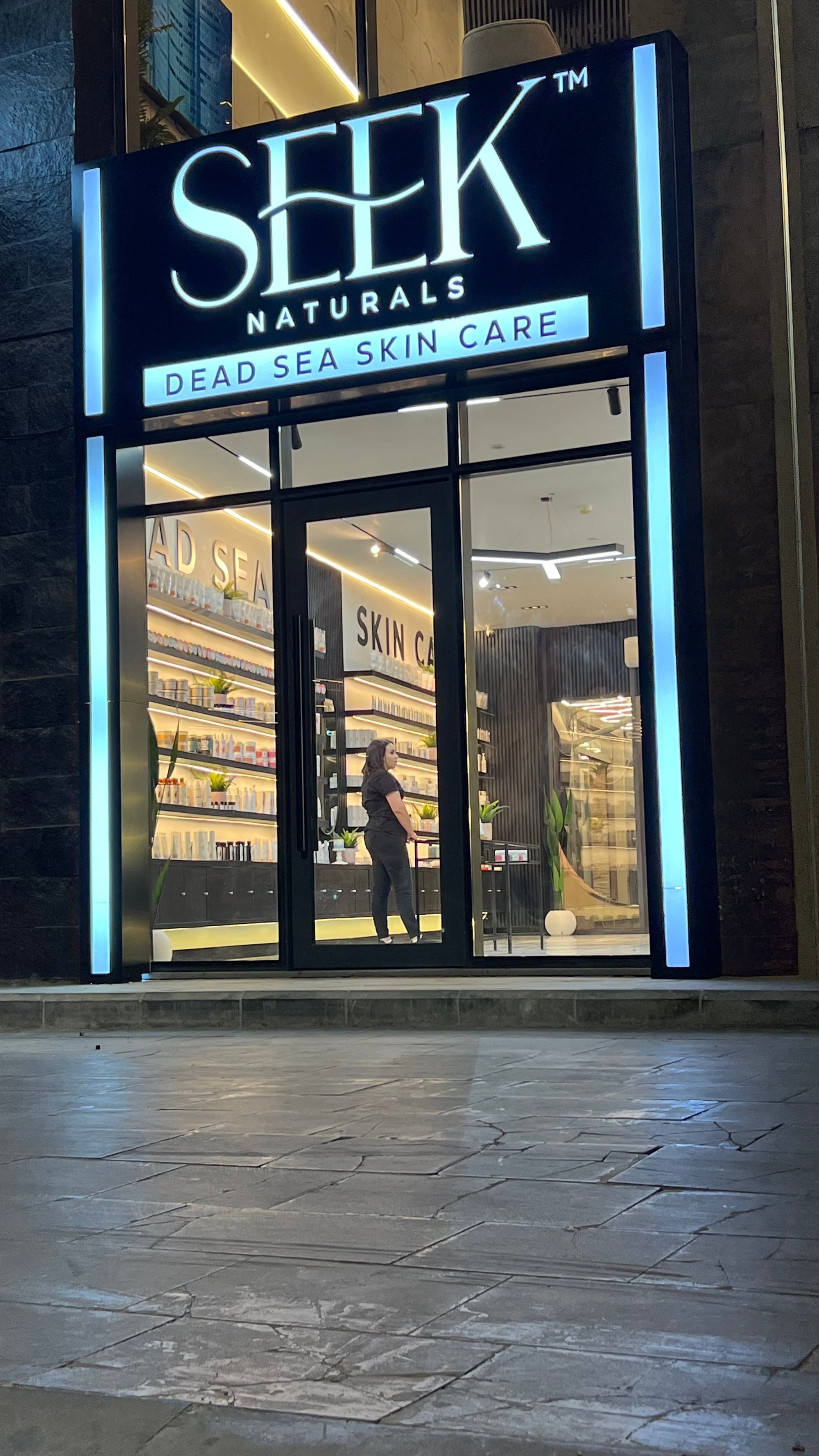 “Exterior of the new SEEK Naturals store showcasing natural skincare and Dead Sea mineral products, with modern signage and inviting store entrance in Hujra Village, Jordan.”