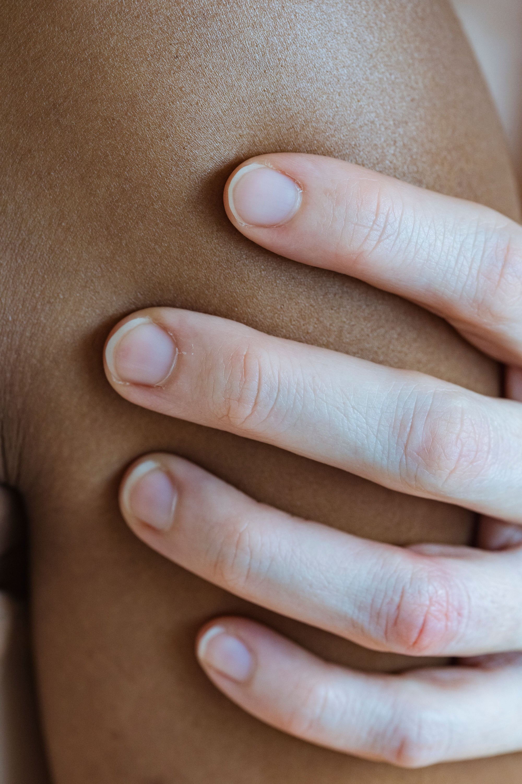 Close-up of healthy skin being gently touched, representing sensitive skin care and skin barrier support
